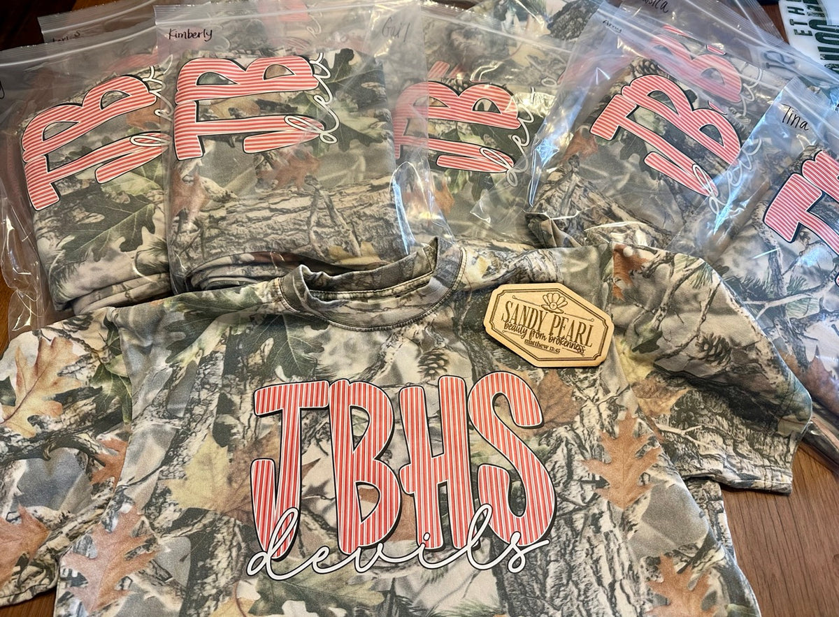 Cotton Collective camo tees with JBHS Devils puff embroidery design, packaged and ready for delivery