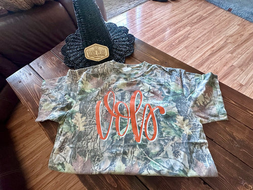 Cotton Collective camo tee with Vols script design in orange on mossy oak camo