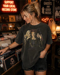 Model wearing Hocus Pocus Boxy Tee in Pepper colorway at a vintage record store