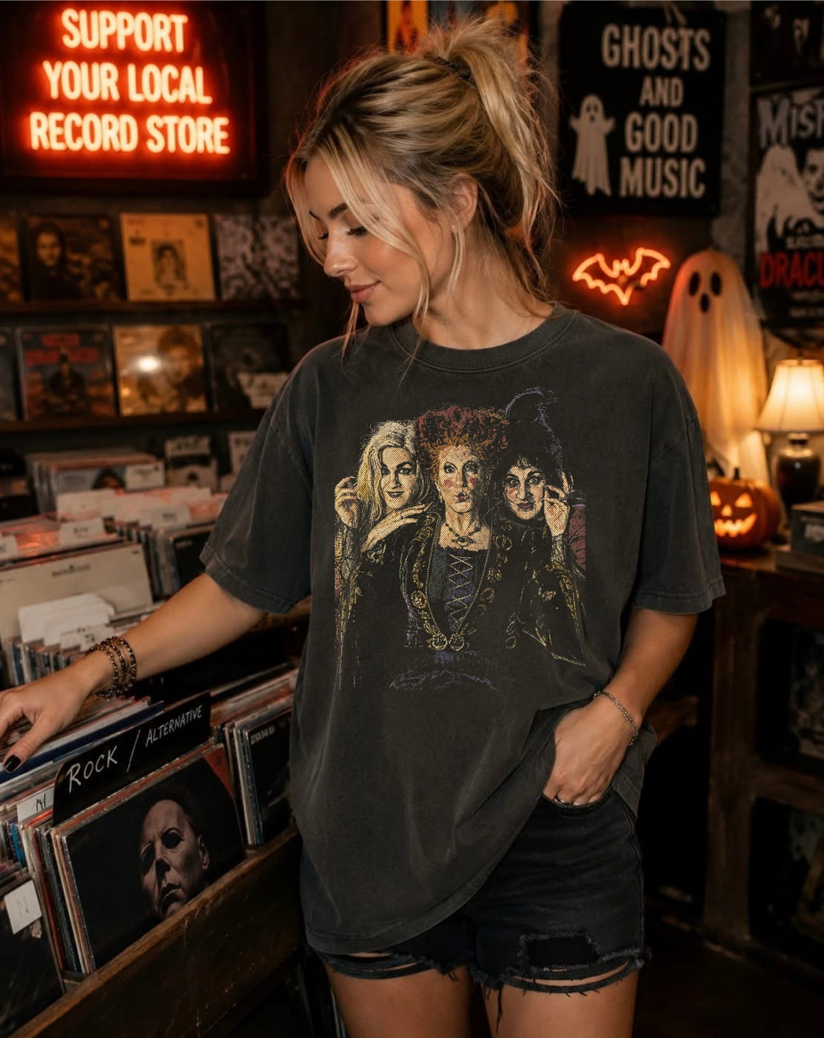 Model wearing Hocus Pocus Boxy Tee in Pepper colorway at a vintage record store