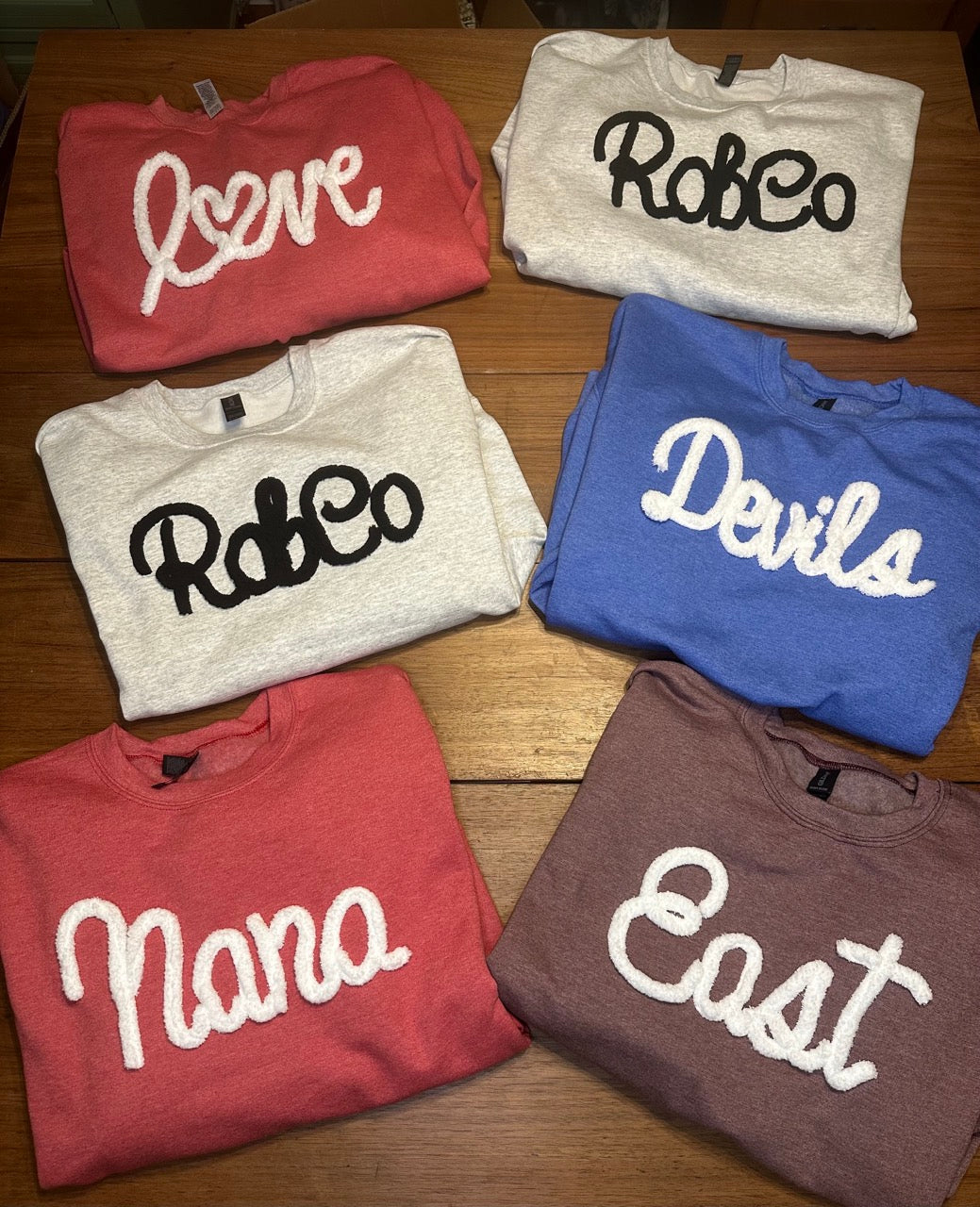 Love and RobCo yarn embroidered crewneck sweatshirts with Sandy Pearl branded tag